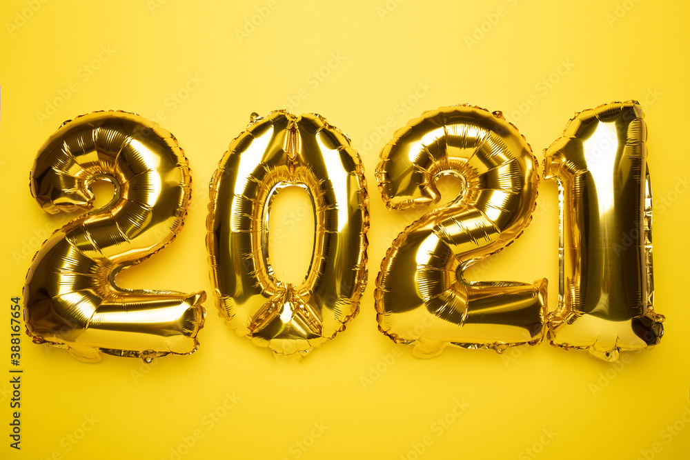Golden foil balloon on yellow background 2021 new year Golden foil balloon on yellow background 2021 new year