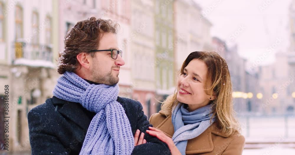 Beautiful woman with blond hair goes to meet her boyfriend and hugs him. Confident Caucasian man waiting for girlfriend on street. Beautiful woman with blond hair goes to meet her boyfriend and hugs him. Confident Caucasian man waiting for girlfriend on street.