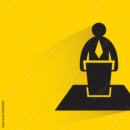 businessman or speaker standing on podium yellow background
