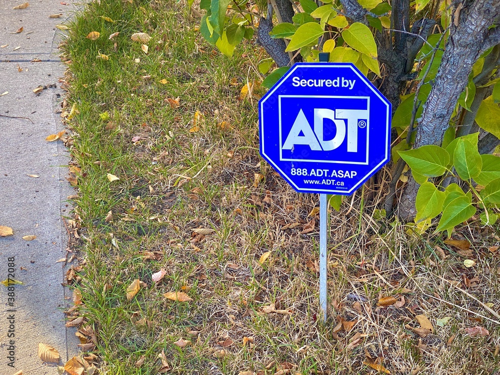 Calgary, Alberta. Canada. Sep 27, 2020. An ADT sign security alarm system.  Photos | Adobe Stock