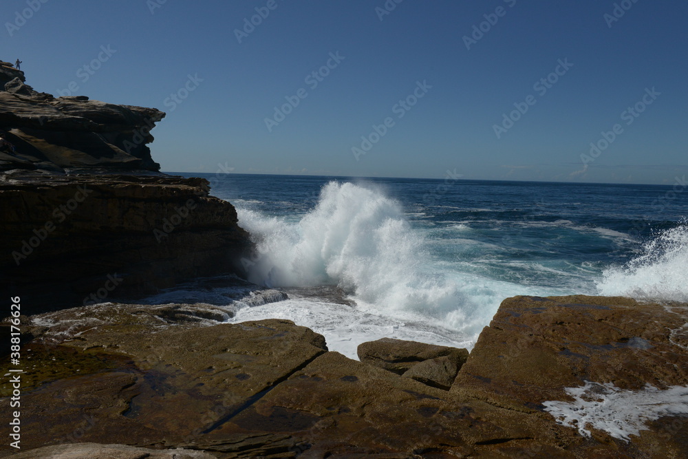 The rocks with the ocean and with the strongwomen waves near the Maroubra beach in Sydney, Australia