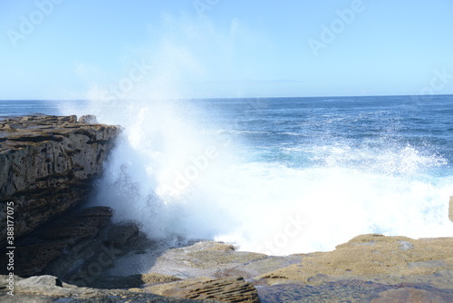 The rocks with the ocean and with the strongwomen waves near the Maroubra beach in Sydney, Australia