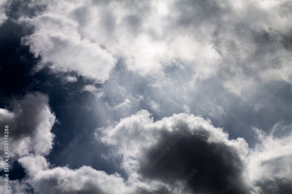 Obraz premium Rain clouds background. Clouds become dark gray like a big smoke before rainfall. Thunderstorm is a storm with lightning and thunder. Air pilots know that they must never fly through a thunder cloud.