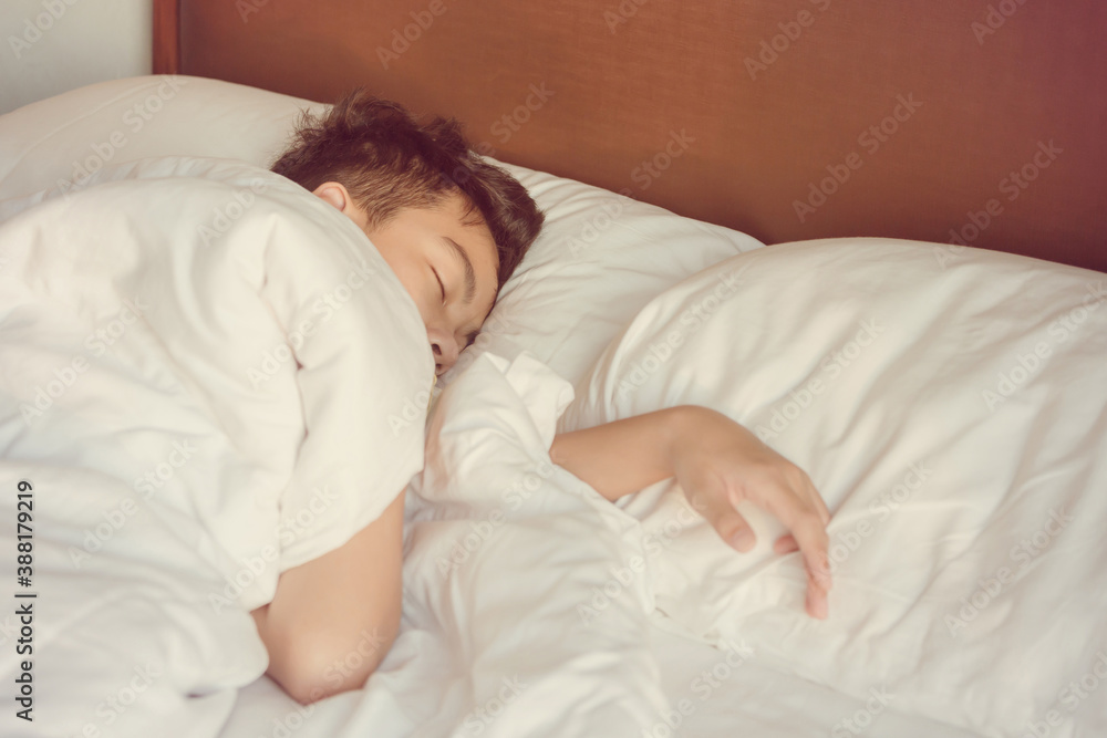 Asian teenage boy sleeps in bed at home Asian teenage boy sleeps in bed at home
