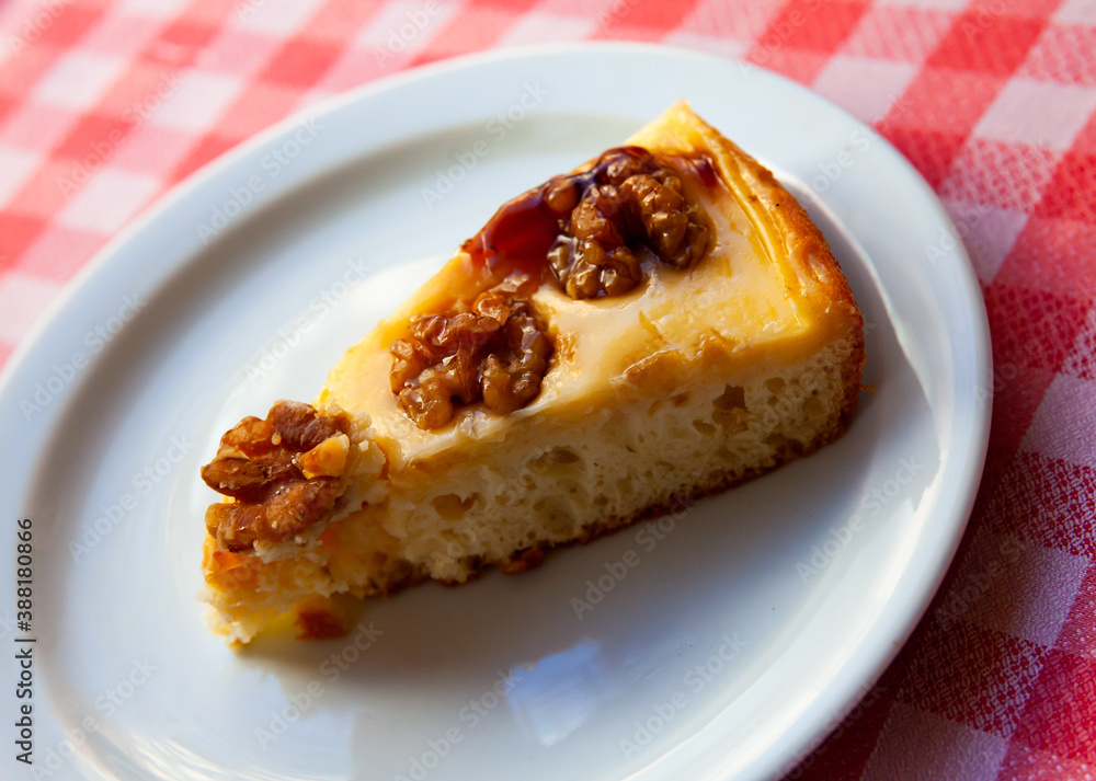 Sweet dessert, cake with walnuts on white plate