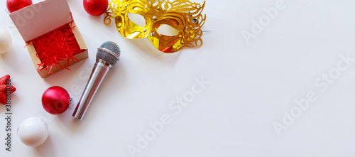Christmas shopping: microphone, Golden mask and Christmas toys. Musical creativity in the new year. isolated on a white background. copy space