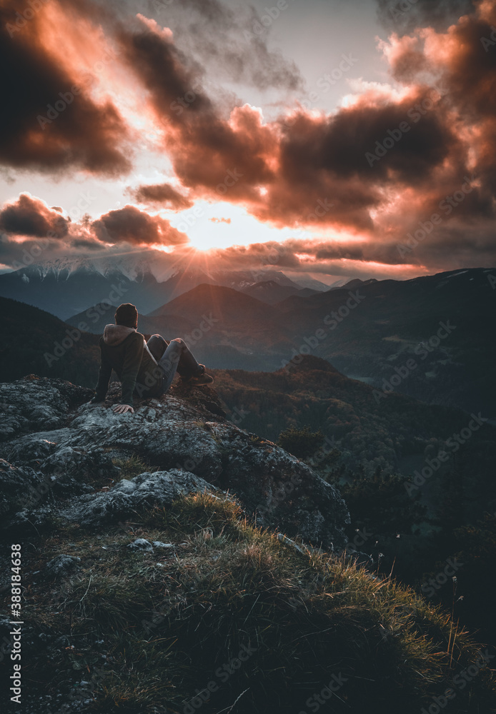 Fototapeta premium girl on mountain watching sunset in autumn