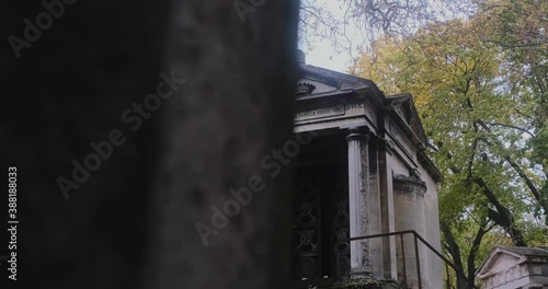a mysterious family vault in the pere lachaise cemetary the metal door is half-open photo