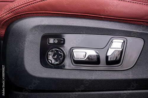 Close-up of height and position adjustment panel for driver's leather seat