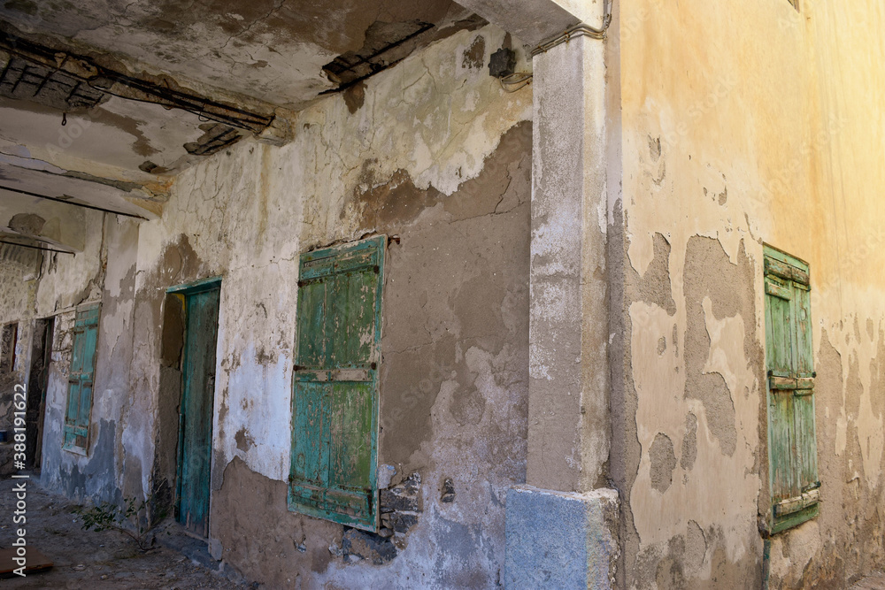 Green Wooden Door and Window Shutters on Old Building at Pedi Beach on the Greek Island of Symi Green Wooden Door and Window Shutters on Old Building at Pedi Beach on the Greek Island of Symi