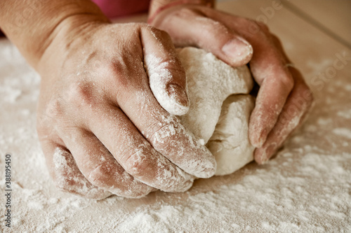 woman chef holding dough with her hands, female hands in flour, female hands with dough