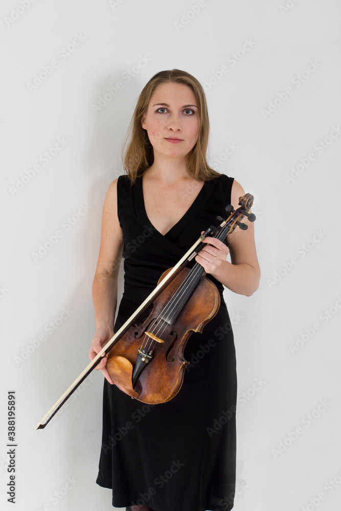 happy young teacher with violin on light background, vertical happy young teacher with violin on light background, vertical
