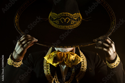 mexican charro holding his black hat photo
