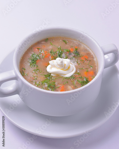 A picture of a bowl of traditional chicken soup served in a bowl over white background.