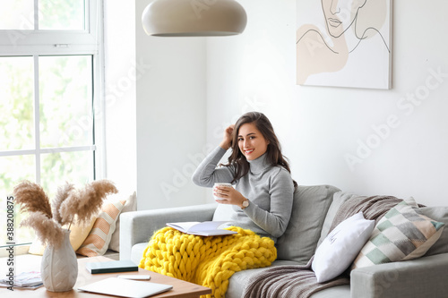 Beautiful young woman drink...
