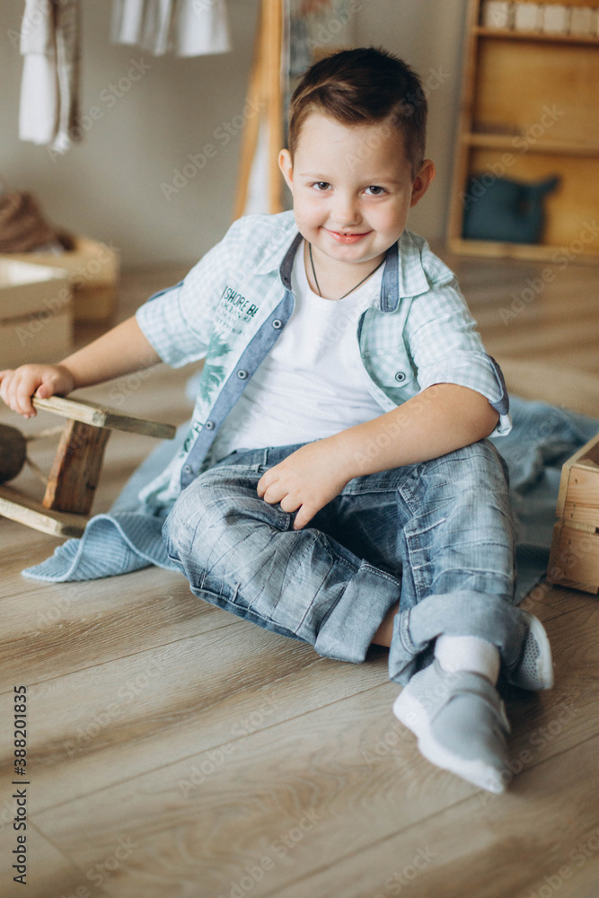 Cute boy playing with wooden airplane at home Cute boy playing with wooden airplane at home