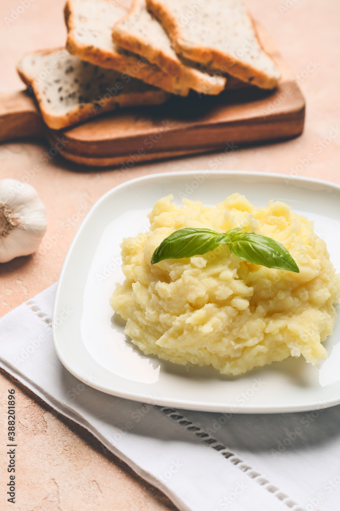 Plate with tasty mashed potato and garlic on table