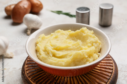 Bowl with tasty mashed potato on table