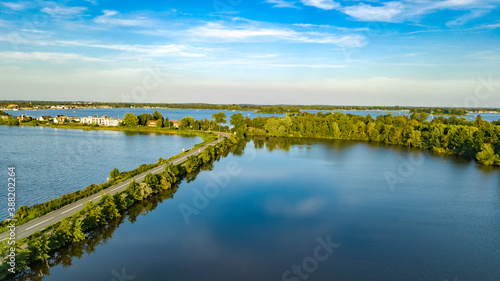Aerial drone view of motorway road and cycling path on polder dam, cars traffic from above, North Holland, Netherlands 