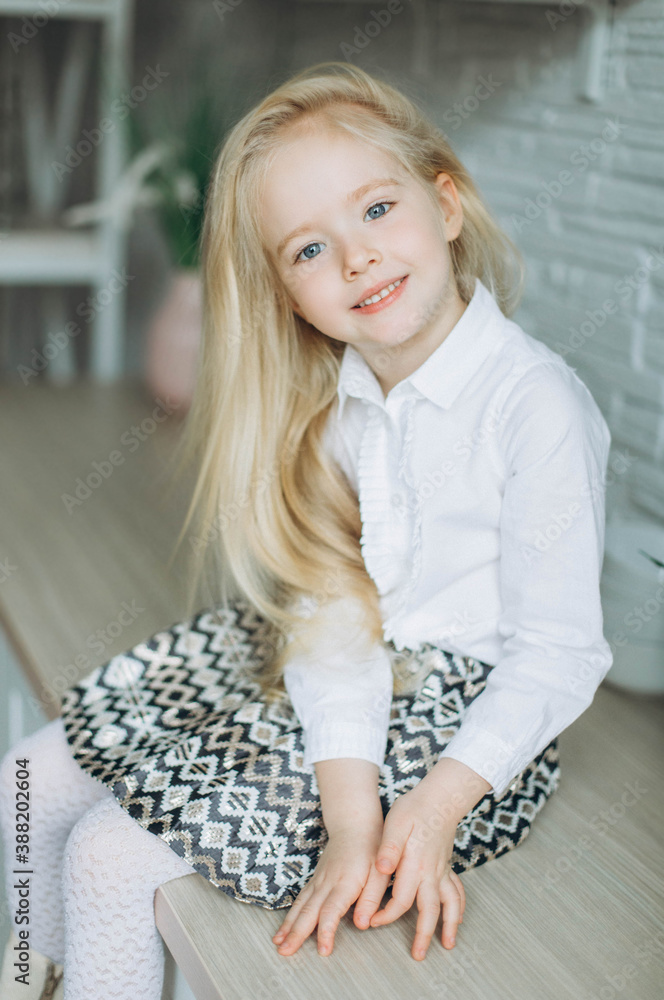 Fototapeta premium Adorable little cute blondie girl smiling at home