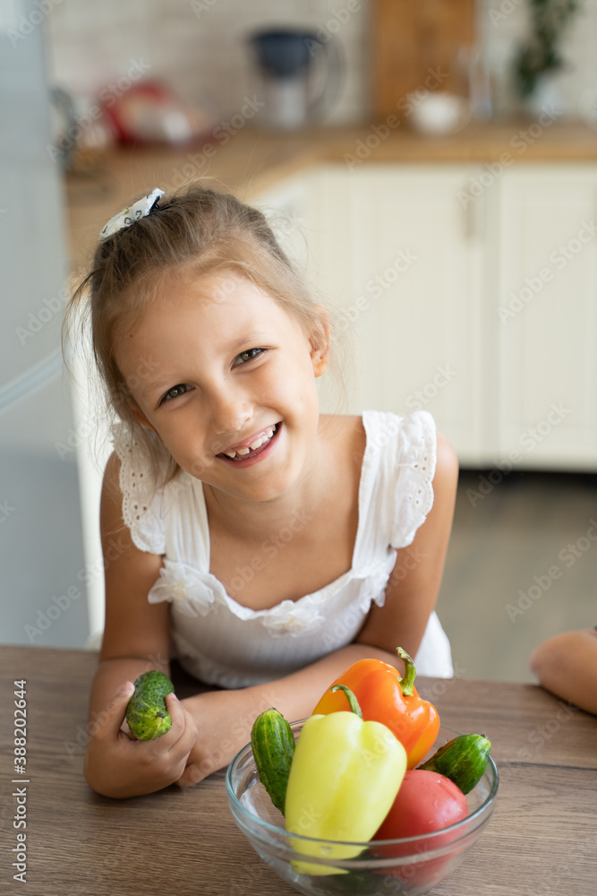 Fototapeta premium little girl with vegetables