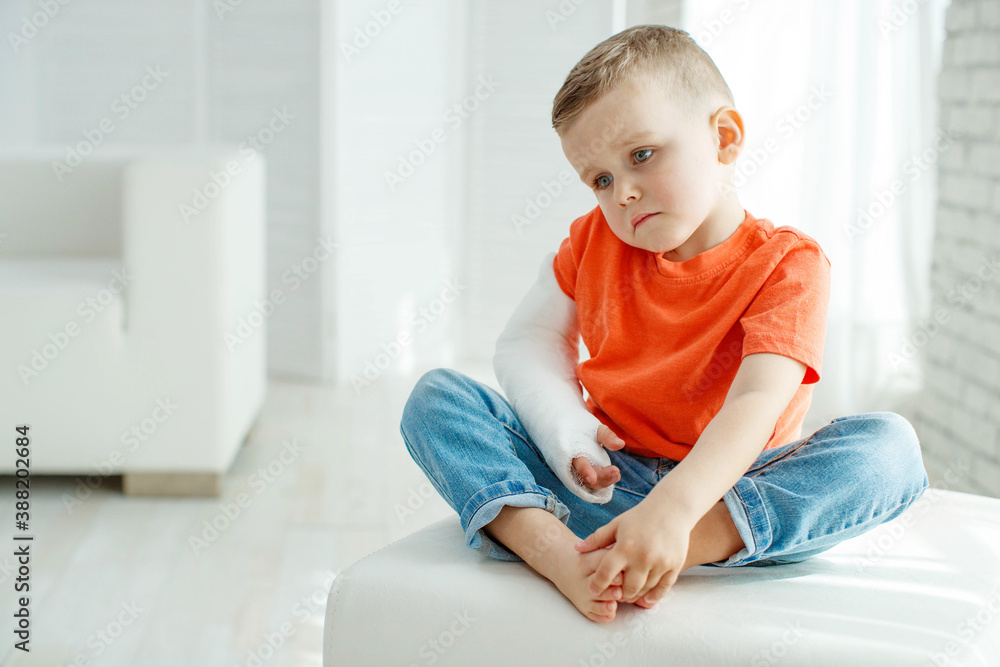 little boy in a cast.child with a broken arm. funny kid after accident. High quality photo. little boy in a cast.child with a broken arm. funny kid after accident. High quality photo.