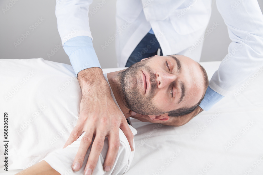 Caucasian doctor massaging patient head. Caucasian doctor massaging patient head.