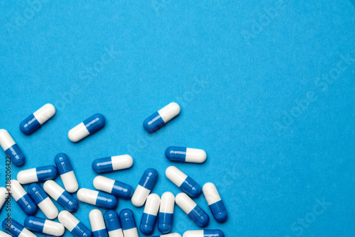 group of pills or capsules on blue background