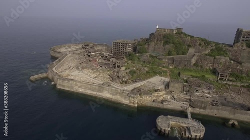 長崎県にある軍艦島。空撮トラックアウト映像。