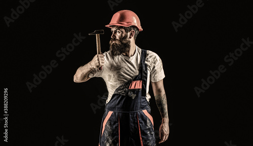 Builder in helmet, hammer, handyman, builders in hardhat. Hammer hammering. Bearded builder isolated on black background. Bearded man worker with beard, building helmet, hard hat