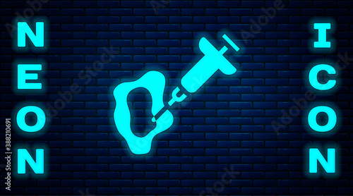Glowing neon GMO syringe icon isolated on brick wall background. Genetically modified organism acronym. Dna food modification. Vector.