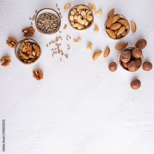 Assorted of nuts on a white background. Space for text, top view