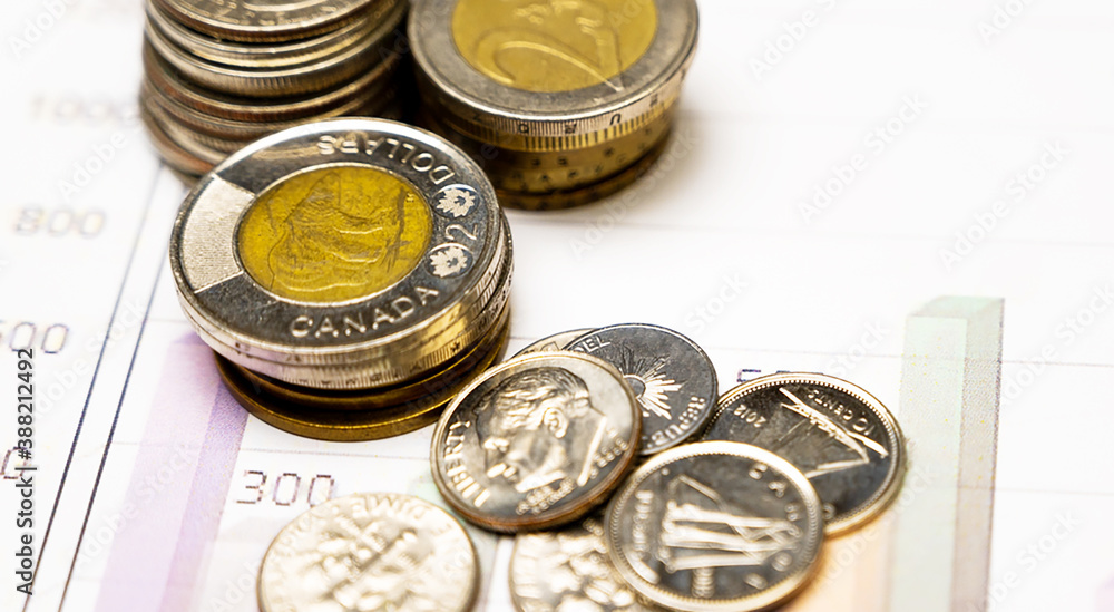 Business and Finance Concept: Stacked silver and golden coins on graphic chart. Business and Finance Concept: Stacked silver and golden coins on graphic chart.