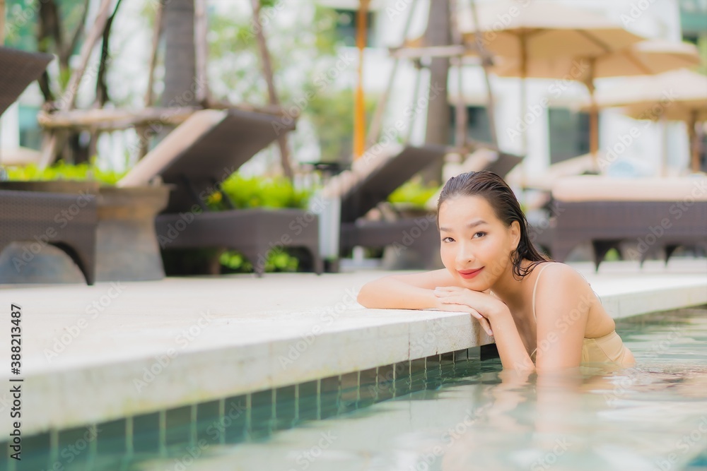 Portrait beautiful young asian woman relax smile around outdoor swimming pool