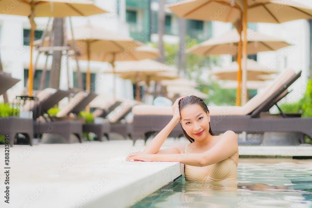 Portrait beautiful young asian woman relax smile around outdoor swimming pool