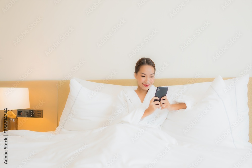 Portrait beautiful young asian woman use smart mobile phone on bed Portrait beautiful young asian woman use smart mobile phone on bed