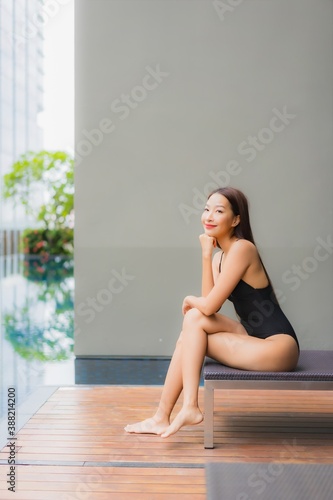 Portrait beautiful young asian woman relax smile around outdoor swimming pool