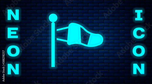 Glowing neon Cone meteorology windsock wind vane icon isolated on brick wall background. Windsock indicate the direction and strength of the wind. Vector.