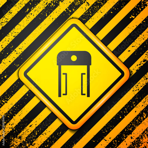 Black Metal detector in airport icon isolated on yellow background. Airport security guard on metal detector check point. Warning sign. Vector.