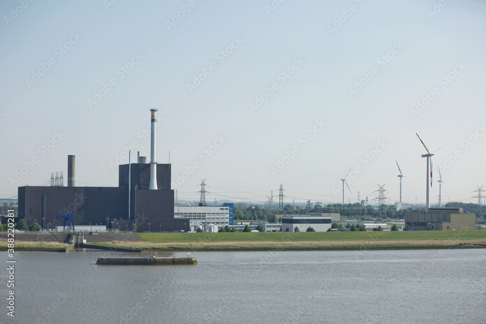 Windmills power plant and turbines generating renewable green energy near to Kiel canal in Germany Windmills power plant and turbines generating renewable green energy near to Kiel canal in Germany