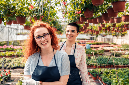 Portrait of two female florists in a greenhouse.