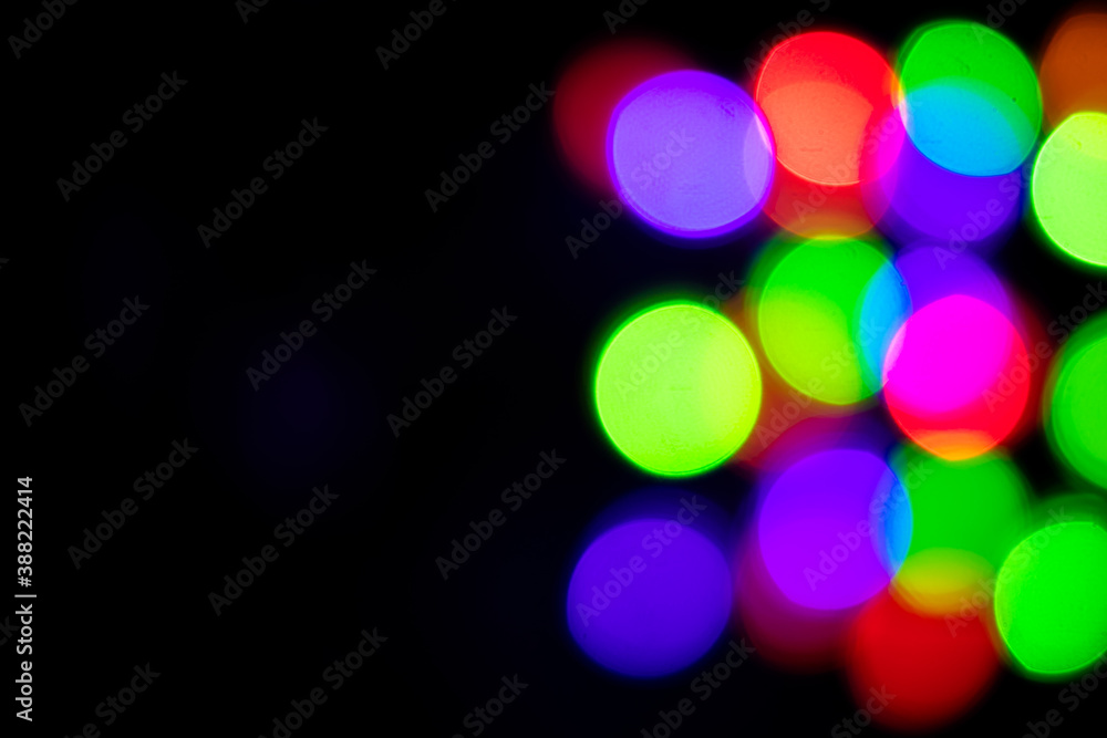 A brilliant glowing background side on black. The glitter light bokeh for the New Year and other holidays. Place for text copyspace. A brilliant glowing background side on black. The glitter light bokeh for the New Year and other holidays. Place for text copyspace.