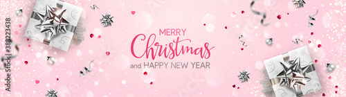 Merry Christmas and New Year text on pink background with silver gift boxes, fir branches, ribbons, decoration, sparkles, confetti, bokeh. Xmas card. Vector Illustration, holiday realistic vector