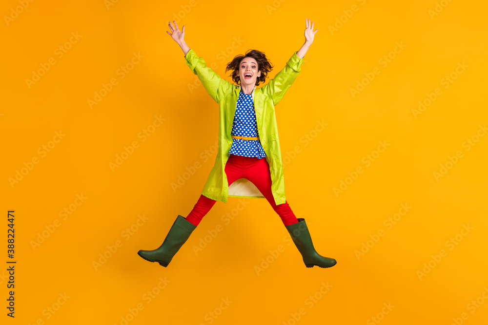 Full length photo portrait of girl jumping up spreading arms legs like star isolated on vivid yellow colored background