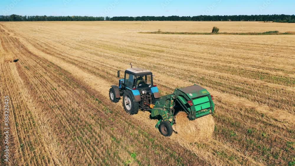 Haymaking carried out by an agricultural machine in the field Haymaking carried out by an agricultural machine in the field