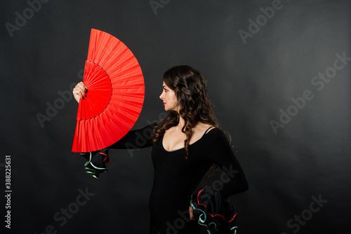 Portrait of beautiful young woman dancing flamenco in studio
