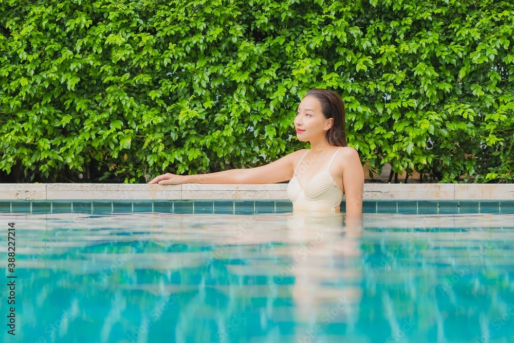 Portrait beautiful young asian woman relax smile around outdoor swimming pool