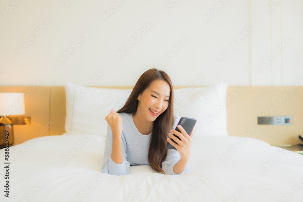 Portrait beautiful young asian woman use smart mobile phone on bed Portrait beautiful young asian woman use smart mobile phone on bed