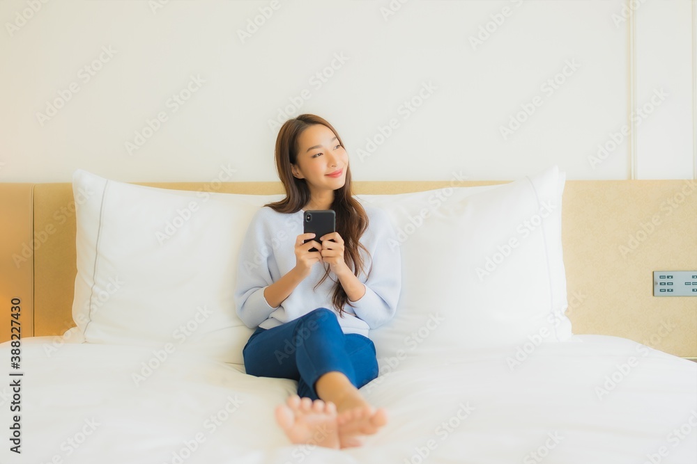 Portrait beautiful young asian woman use smart mobile phone on bed Portrait beautiful young asian woman use smart mobile phone on bed