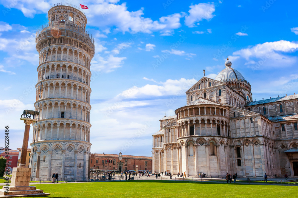 Panorama of the Cathedral of Our Lady of the Assumption and its leaning campanile made famous around the world as well as the Roman she-wolf in Pisa, Tuscany, Italy